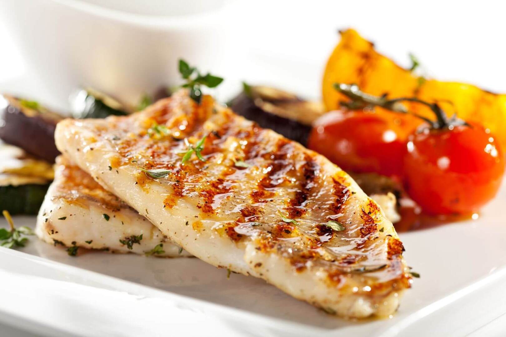 A photo of grilled fish fillet with vegtables